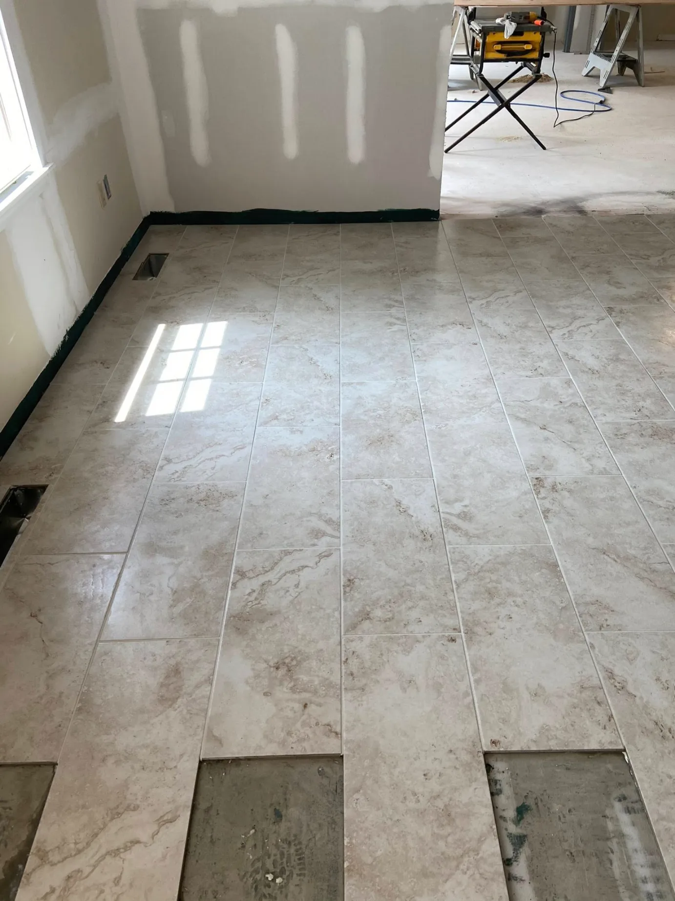 Large format stone look porcelain floor tile installation in a staggered running bond pattern by DMtilellc in Darien CT
